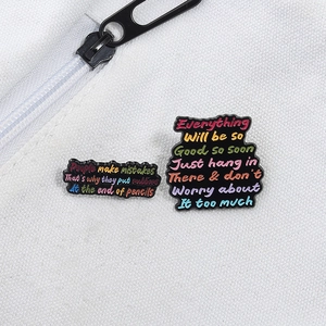 Funny enamel quote pins set on canvas background with metallic alphabet art design