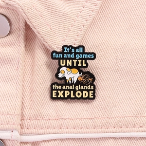 Détail d'une broche en émail de chien avec texte d'humour sur un col de veste rose