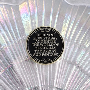 Retro black and gold round metal badge with fantasy theme slogan and ornate patterns