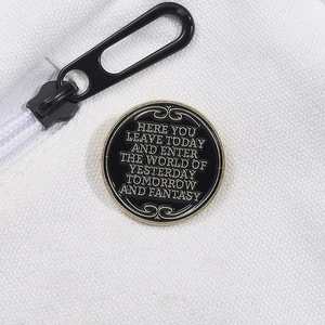 Black round enamel pin with gold text quoting the entrance plaque of Disneyland