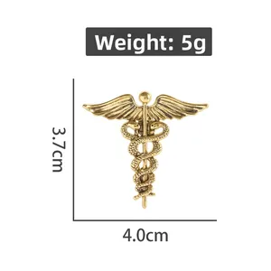 Detail view of gold vintage caduceus brooch with wings and snakes weighing 5g at 4x3.7cm