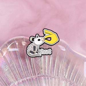 Funny opossum enamel pin with shut text on shell tray with pink plush background