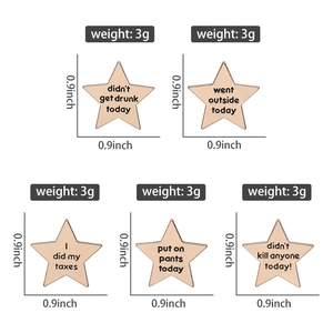 Macro shot of rose gold star-shaped pins featuring humorous English text on metal