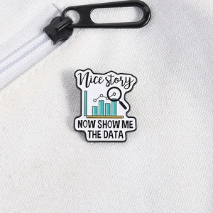 Close-up of enamel data styling brooch with bar charts and magnifying glass design
