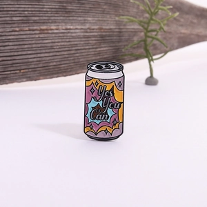 Cartoon enamel pin shaped like a soda can featuring 'Yes You Can' motivational quote