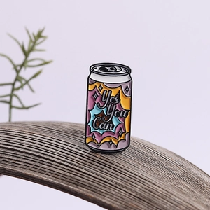 Enamel soda can brooch featuring Yes You Can text on a minimalist wooden base
