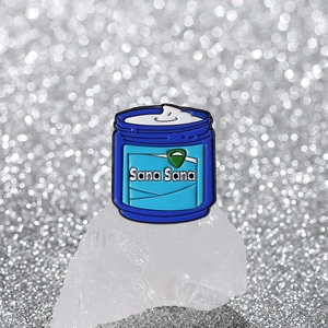 Blue cream jar enamel pin with Sana Sana text on a sparkling silver background