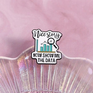 Enamel pin with data analysis theme, charts and 'Show me the data' text on shell