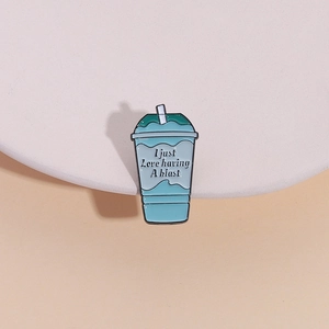 Blue enamel drink cup pin with 'I just Love having A blast' text on a white pedestal