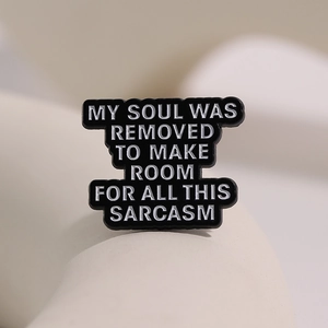 Minimalist enamel pin with sarcasm text on black background for clothes and backpacks