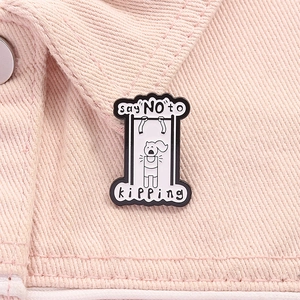 Detail of enamel pin with say NO to kipping text on a pink denim jacket background
