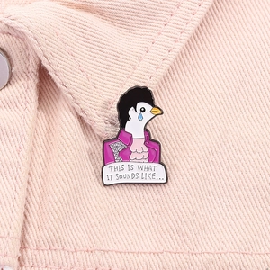 Detail of crying dove enamel pin with purple jacket pinned on pink denim jacket collar