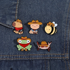Set of cute cartoon western cowboy enamel pins with animals on denim background