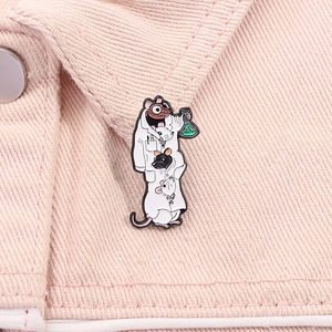 Close-up of lab mice enamel pin on denim jacket featuring cute rats in a white lab coat