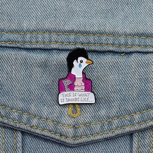 Close-up of Prince enamel pin on denim jacket featuring When Doves Cry lyrics