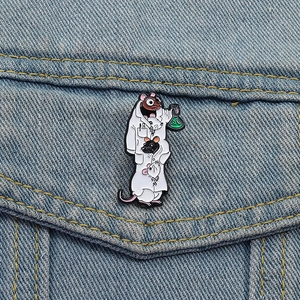Detail of lab mice enamel pin with green flask pinned on blue denim jacket pocket