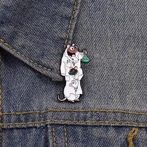 Close-up of a cartoon lab rat enamel pin with green flask on blue denim fabric