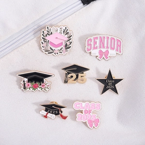 Close-up of Class of 2025 enamel graduation pins set with senior and star motifs