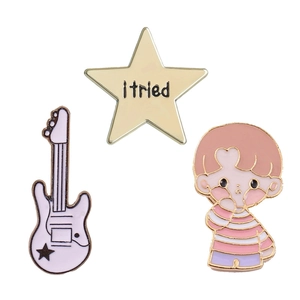 Set of 3 enamel pins featuring a white guitar, gold star, and cartoon boy for backpacks