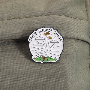 Detail of enamel pin featuring a cartoon white goose and God's Silliest Goose text