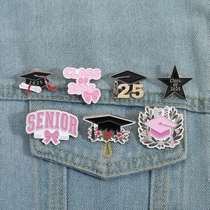 Close-up of Class of 2025 enamel graduation pins on a blue denim jacket pocket