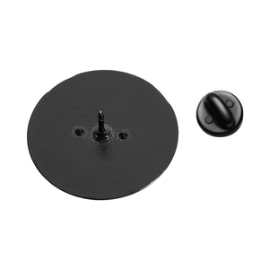 Detail view of round metal badge backing with fixing pins and black butterfly clasp