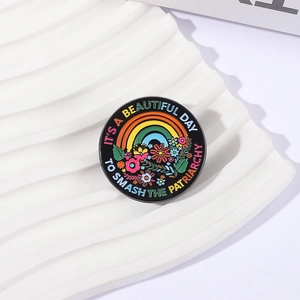 Enamel brooch with rainbow, flowers and It's A Beautiful Day To Smash The Patriarchy slogan