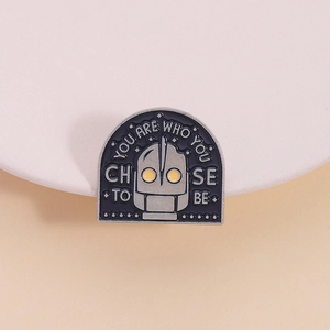 Iron Giant enamel pin featuring a robot head and the quote YOU ARE WHO YOU CHOOSE TO BE