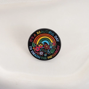 Colorful floral enamel pin badge with Smash the Patriarchy quote on white background