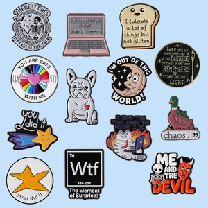Set of 12 creative cartoon animal and letter enamel pins on a light blue background