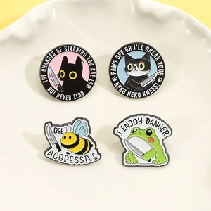 Four-piece set of cartoon animal enamel pins featuring a black cat, bee, and frog designs