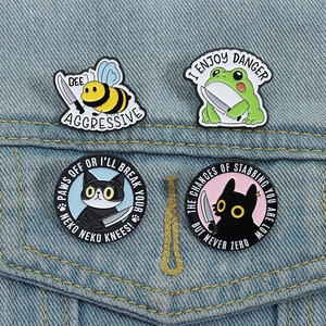 Close-up of four funny cartoon animal enamel pins pinned on a blue denim jacket pocket