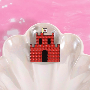 Macro shot of red castle enamel pin with star flag details on white shell background