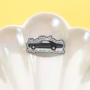 Creative black vintage car enamel pin with Supernatural quote on a pearl shell plate