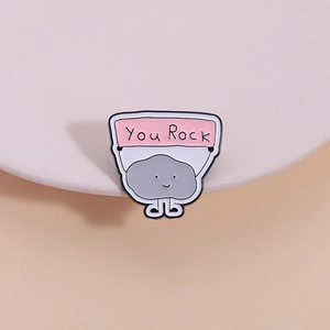 Cartoon grey cloud stone enamel pin with You Rock sign on a pastel decorative stand