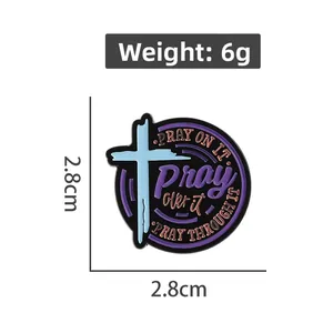 Detail showing 2.8cm round enamel prayer badge dimensions and inspirational text on black