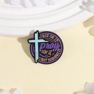 Religious prayer enamel pin with blue cross and Pray On It text on white display
