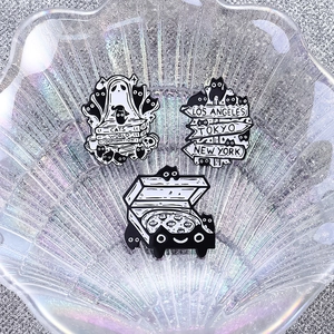 Detailed close-up of creative black and white cat alloy badges on a decorative tray