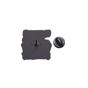 Detail view of the black rubber clutch and metal pin backing for enamel brooches