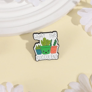 Cartoon succulent enamel pin with 'What the Fucculent' pun on a decorative background
