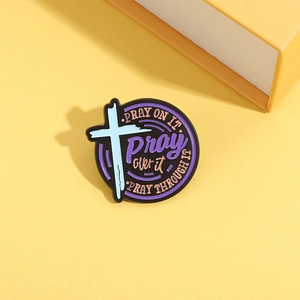Round enamel brooch with inspirational pray quotes and cross on purple background