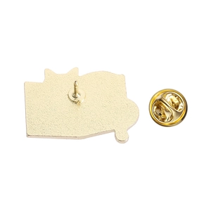 Close-up of the golden metal pin back with textured surface and butterfly clutch fastener