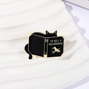 Funny black cat reading To Kill a Mockingbird book enamel pin for book lovers