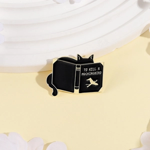 Funny black cat reading To Kill a Mockingbird enamel pin with gold alloy detailing