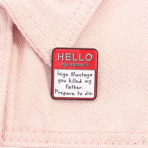 Macro shot of Hello My Name Is square enamel pin on light pink denim fabric