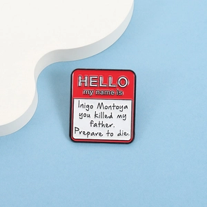 Macro detail of 'HELLO my name is' enamel pin with classic movie quote on blue background