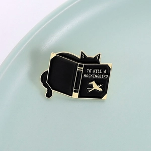 Funny black cat hiding behind To Kill a Mockingbird enamel book pin for book lovers