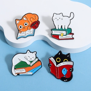 Detailed view of four colorful enamel cat and book lapel pins on a cloud display
