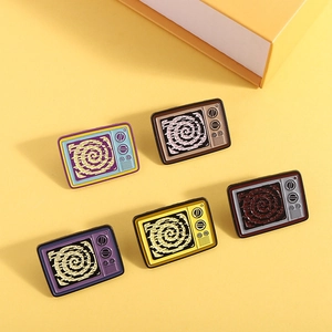 Detailed view of colorful retro TV enamel pins set on a vibrant yellow background