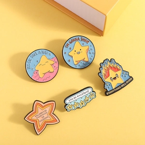 Five-piece cartoon star enamel pin set with positive quotes on a warm yellow background